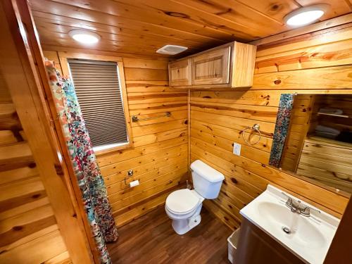 a wooden bathroom with a toilet and a sink at JW Grand Junction in Grand Junction