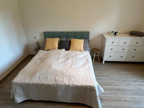 a bedroom with a large bed and a dresser at Chalupa na vesnici - Blansko in Chrudim