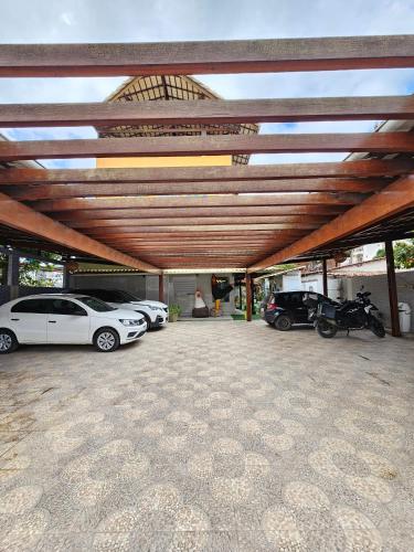 a group of cars parked in a parking lot at Pousada Asahi in Porto De Galinhas