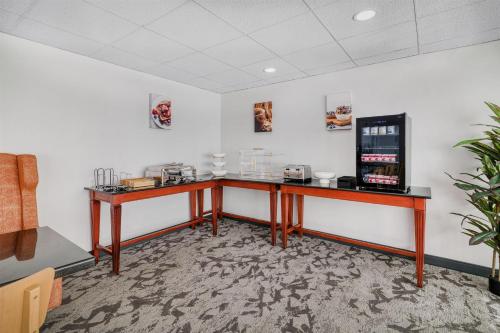 a room with a desk with a coffee machine at Baldwin Inn & Suites, SureStay Collection by Best Western in West Springfield