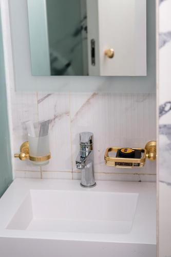 a bathroom with a sink with a mirror and a sink at Chic Hotel in Rabat