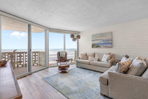 a living room with a view of the ocean at Golden Arms 602 in New Smyrna Beach