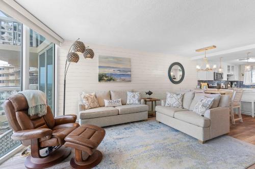 a living room with a couch and a chair at Golden Arms 602 in New Smyrna Beach