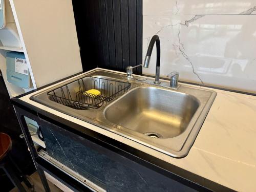 a kitchen sink with a sponge in a strainer at Villas Na-tiva Guanacaste in Plazuela