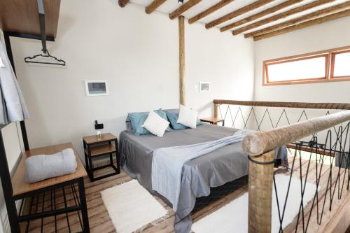 a bedroom with a bed with blue pillows at Esmeraldas GuestHouse in Esmeraldas