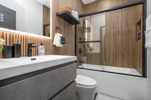 a bathroom with a sink and a toilet and a tub at Entire House Free Parking Sleeps 26 MIT Harvard TD in Somerville