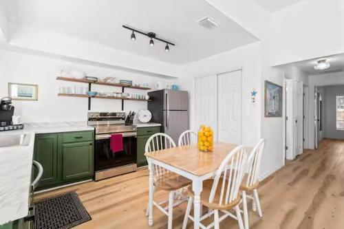 a kitchen with a wooden table and green cabinets at Pet Friendly Crystal River Retreat for the Family in Crystal River