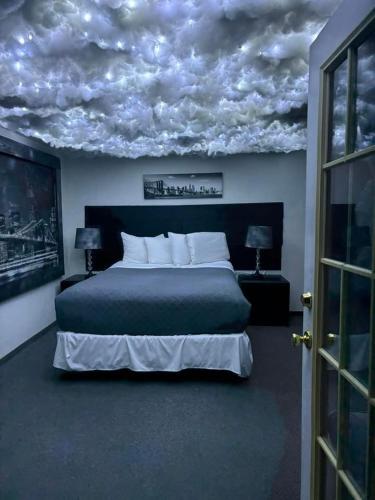 a bedroom with a bed with clouds painted on the ceiling at Bennett Bay Inn in Coeur d'Alene