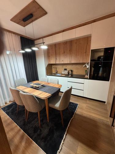 a kitchen with a dining room table and chairs at Casa Brava villas in Novoberdo