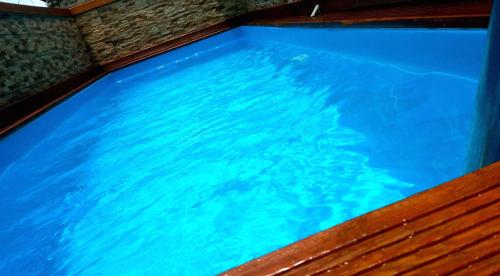 an overhead view of a swimming pool with blue water at Butterfly Hostel in Saint-François