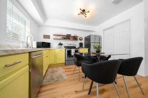 a kitchen with yellow cabinets and a table and chairs at Drift & Dream Getaway Relax After Your Adventure with your Family in Crystal River