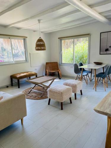 a living room with a table and chairs at Parque Laguna de Zapallar in Maitencillo