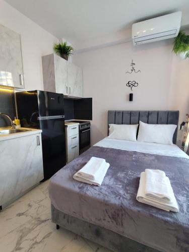 a bedroom with a large bed with towels on it at Valaoritou Luxury Jacuzzi by Dimcol 1 in Thessaloniki