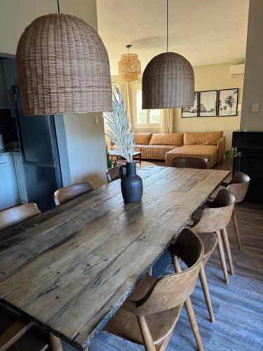 ein Esszimmer mit einem Holztisch und Stühlen in der Unterkunft Casa familiar en Carrasco, playa in Montevideo