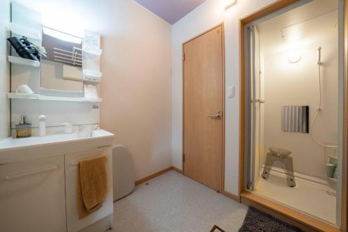 a bathroom with a toilet and a sink and a shower at Maison Omachi 101 - Vacation STAY 20136 in Kami-furano