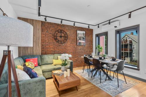 a living room with a couch and a table at Entire House Free Parking Sleeps 26 MIT Harvard TD in Somerville