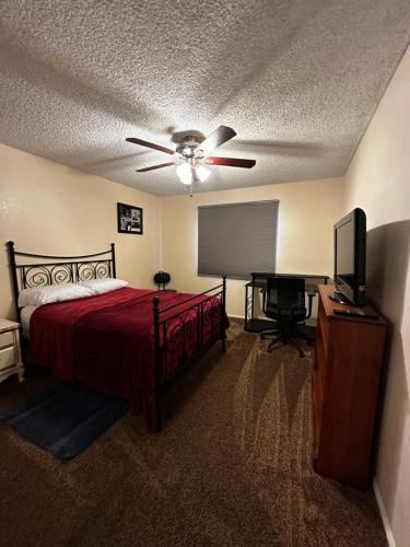 a bedroom with a bed and a flat screen tv at Arizona cozy place in Mesa