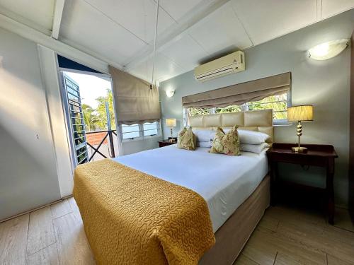 a bedroom with a large bed and a window at Musgrave Avenue Guest Lodge in Durban