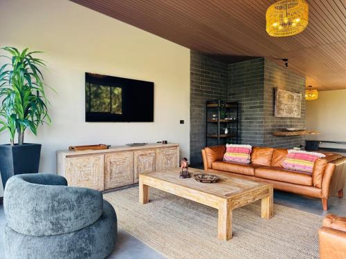 a living room with a couch and a coffee table at Exclusive Villa - Lake View - Forest in La Pradera