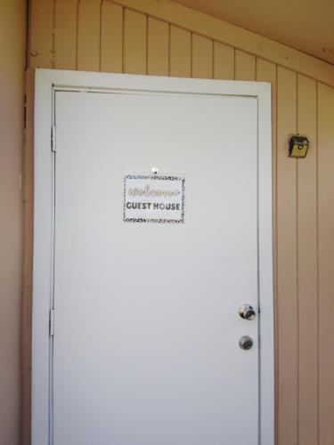 a sign on a white door with a trust house sign on it at Spacious Studio with Pool access & bathroom kitchen in West Palm Beach in West Palm Beach