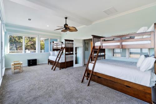 a bedroom with two bunk beds and a ceiling fan at OP58: 58 Ocean Point in Isle of Palms
