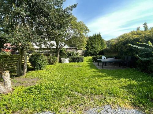 a garden with a picnic table in the grass at F27-K, 4 people, 4 bedrooms, fully furnished in Aalborg