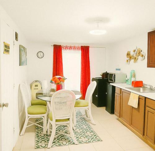 a kitchen with a table and chairs in a kitchen at Spacious Studio with Pool access & bathroom kitchen in West Palm Beach in West Palm Beach