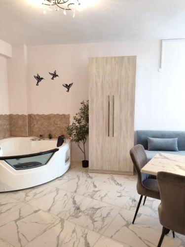 a living room with a tub and a table at Valaoritou Luxury Jacuzzi by Dimcol 2 in Thessaloniki