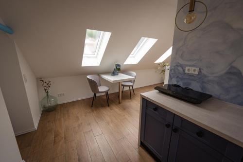 a kitchen with skylights and a table and chairs at Himmel Suite in Schönau an der Brend