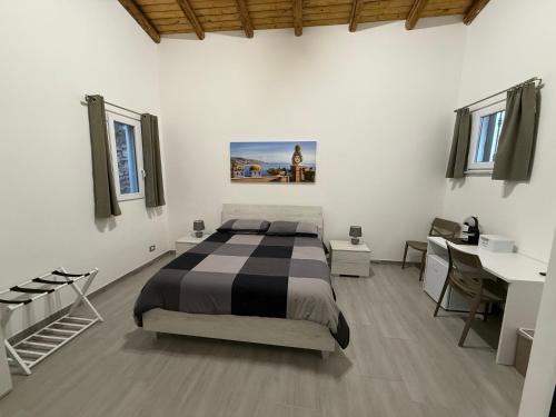 a bedroom with a bed and a desk in a room at DM Rooms in Catania