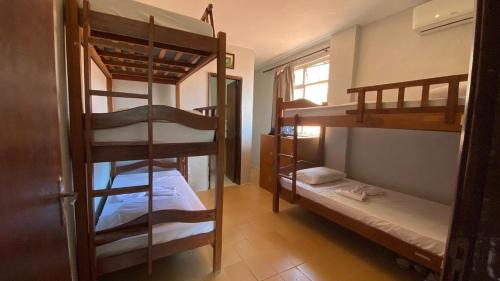 a room with several bunk beds in a room at Maréia Hostel in Salvador