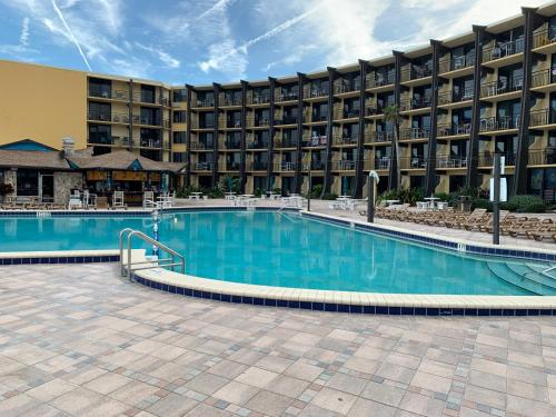 a swimming pool in front of a hotel at Oceanfront on Daytona Beach in Daytona Beach Shores