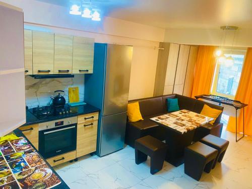 a kitchen with a small table and a kitchen with a stove at Odyssey in Chişinău