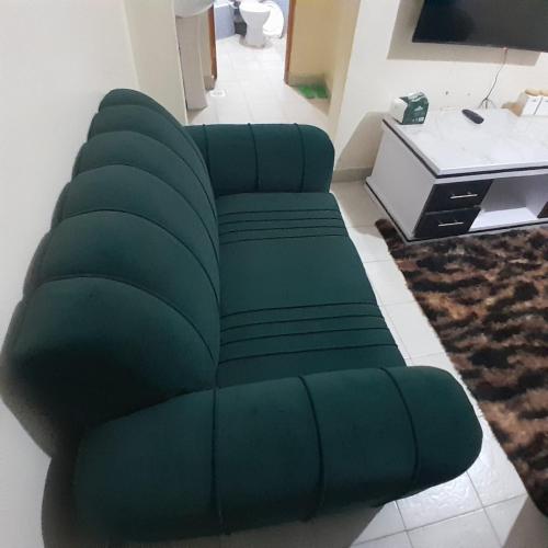 a green couch sitting in a living room at Langata bnb in Nairobi