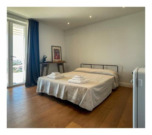 a bedroom with a bed with towels on it at Villa Patrizia Pietrasanta in Pietrasanta