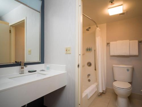a bathroom with a sink and a toilet and a shower at Courtyard Sacramento Airport Natomas in Sacramento