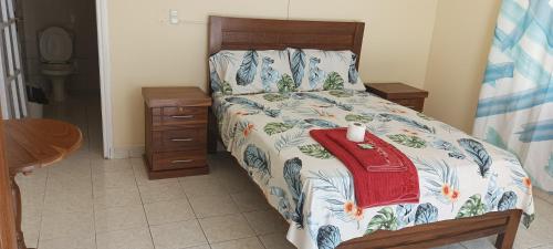 une chambre avec un lit avec un couvre-lit fleuri dans l'établissement Hostal Brillo de Sol, à Santa Cruz de la Sierra