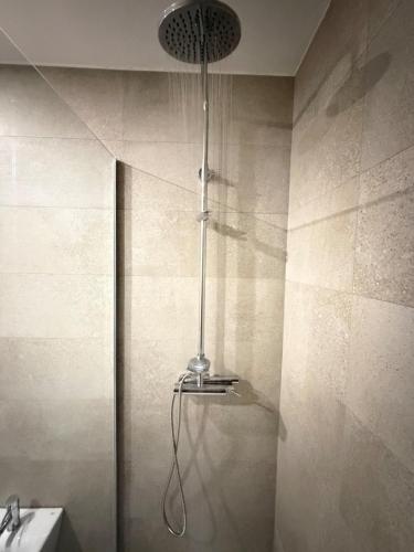 a shower with a light in a bathroom at Casa Brasão - Celorico de Basto in Celorico de Basto