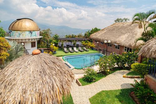 a resort with a swimming pool and a building at Ecovilla Cali in Cali