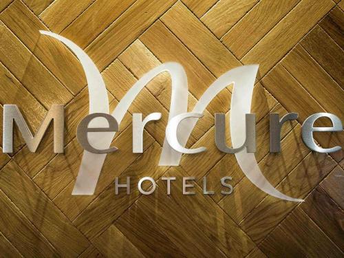 a sign for a hotel on a wooden floor at Mercure Doncaster Centre Danum Hotel in Doncaster