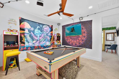 a room with a pool table and a painting at 4BR Private Pool Villa with Arcade Lanai and Water View in Indio