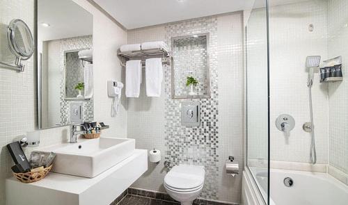 a bathroom with a sink and a toilet and a shower at Nile Cruise 3 & 4 & 7 Nights in Luxor