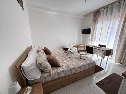 a bedroom with a bed and a table and chairs at Home Sorrento in Torre del Greco