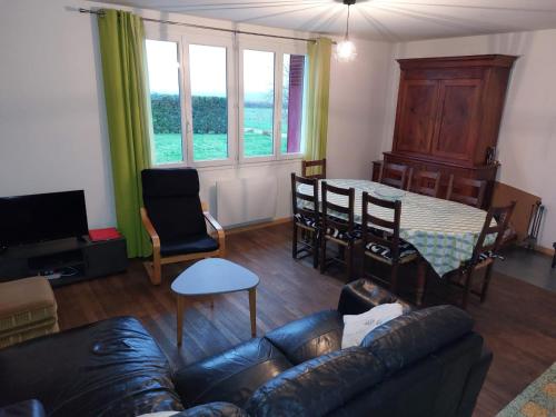 a living room with a couch and a table at gite isolée proche futuroscope Airvault in Saint-Clair
