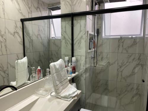 a bathroom with a shower and a sink and a mirror at Apartamento Proximo ao Salvador Shopping in Salvador