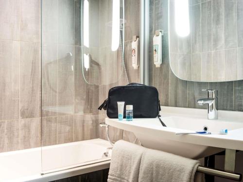 ヴズールにあるibis Vesoulの洗面台、シャワー、トイレ付きのバスルーム