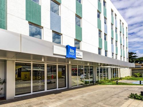 a large building with a blue sign on it at ibis budget Recife Jaboatão in Recife