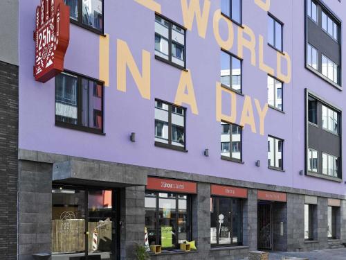 a purple building with a sign that reads world in a day at 25hours Hotel The Trip in Frankfurt/Main