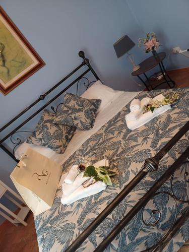 a bed with two towels and shoes on it at Casa Vacanza Io e Te in San Marco Argentano