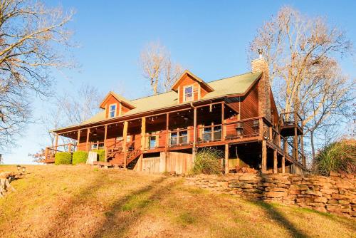 a large wooden house on top of a hill at 15 Mins to U of A - Pool & Hot Tub in Fayetteville